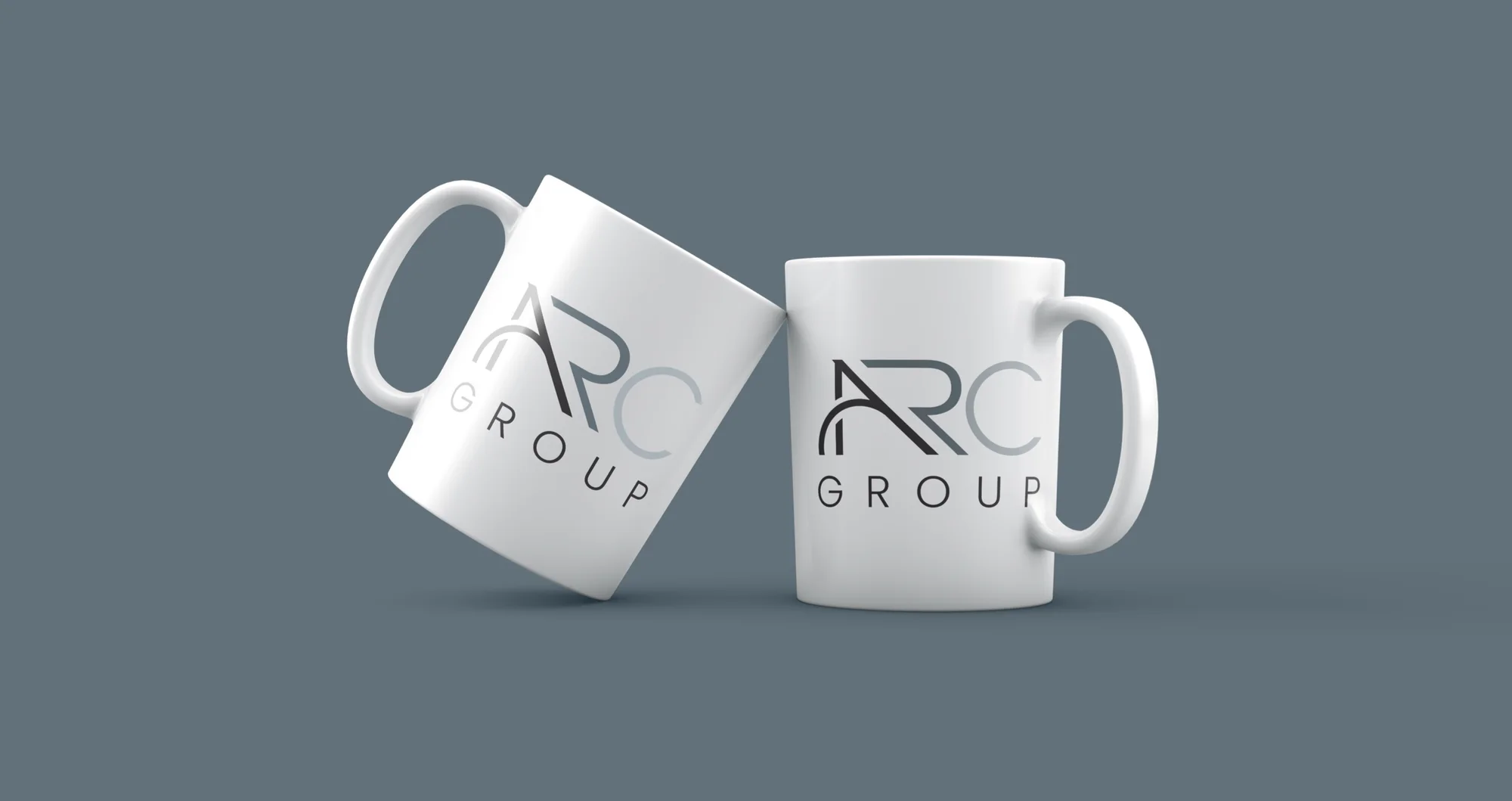 Two white mugs with the three-colour ARC Group logo on an A Gray ground.