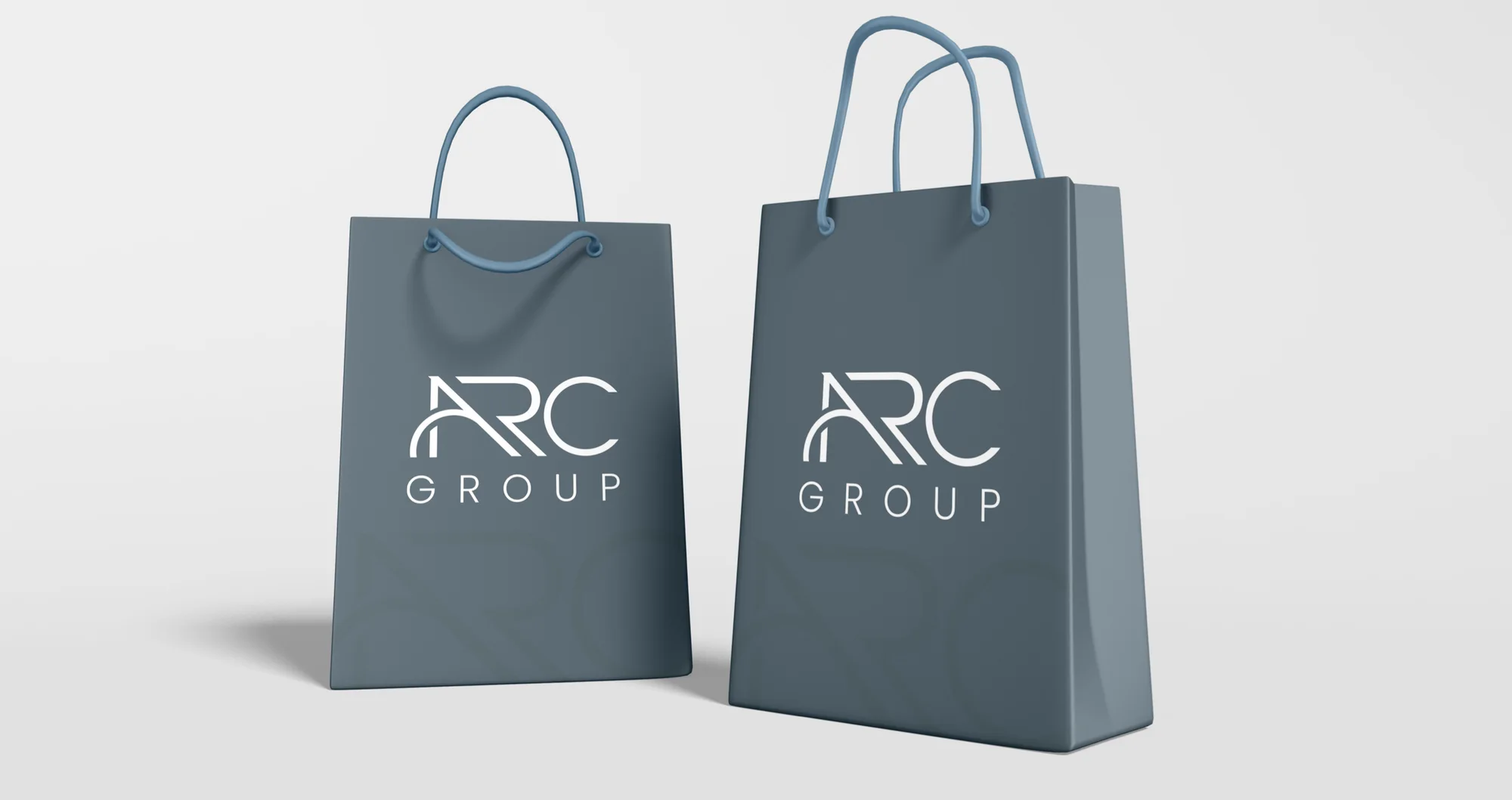 Two A Gray paper bags with a white logo on light grey.