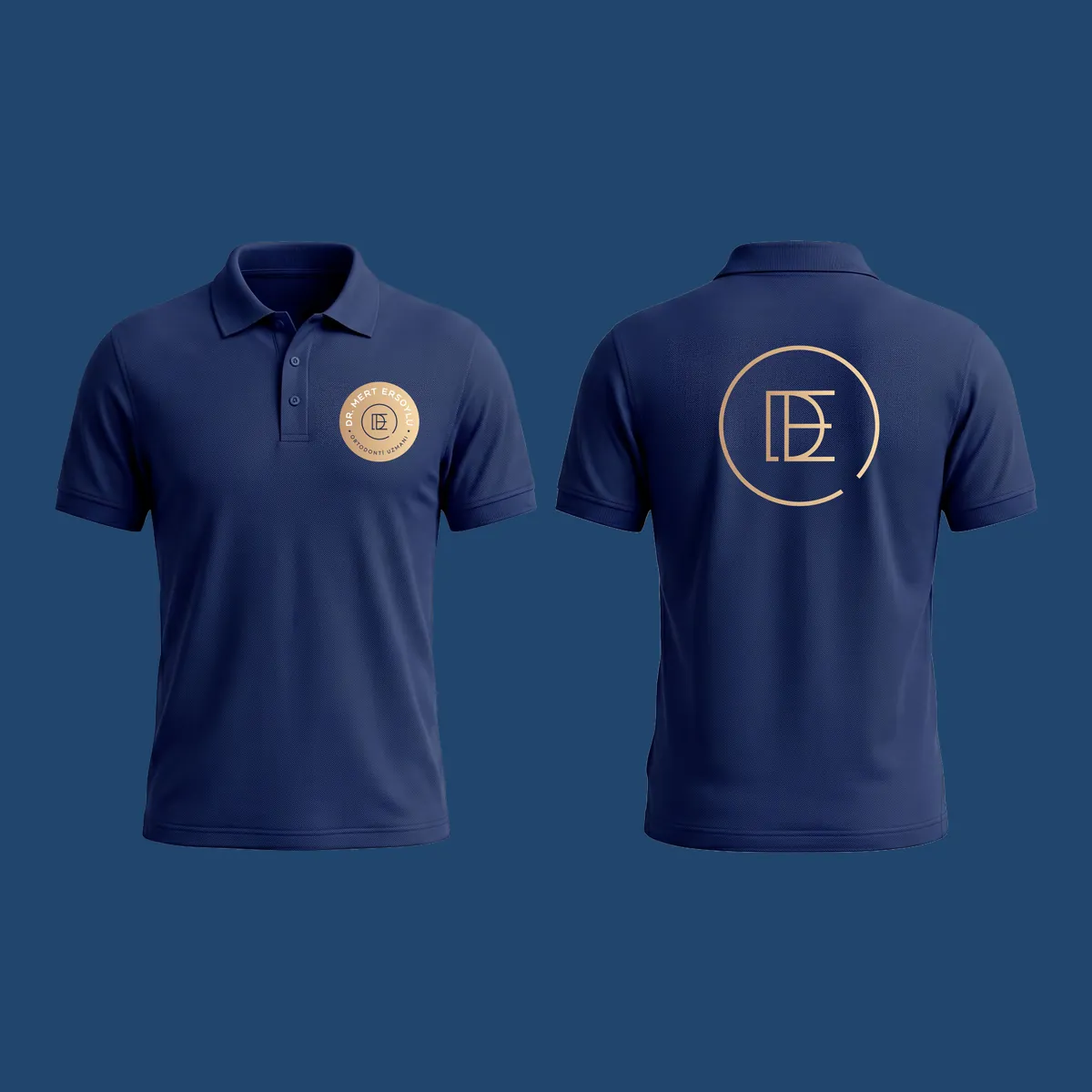 Lacivert polo yaka tişört: önde göğüste gold mühür, arkada büyük ME monogramı.