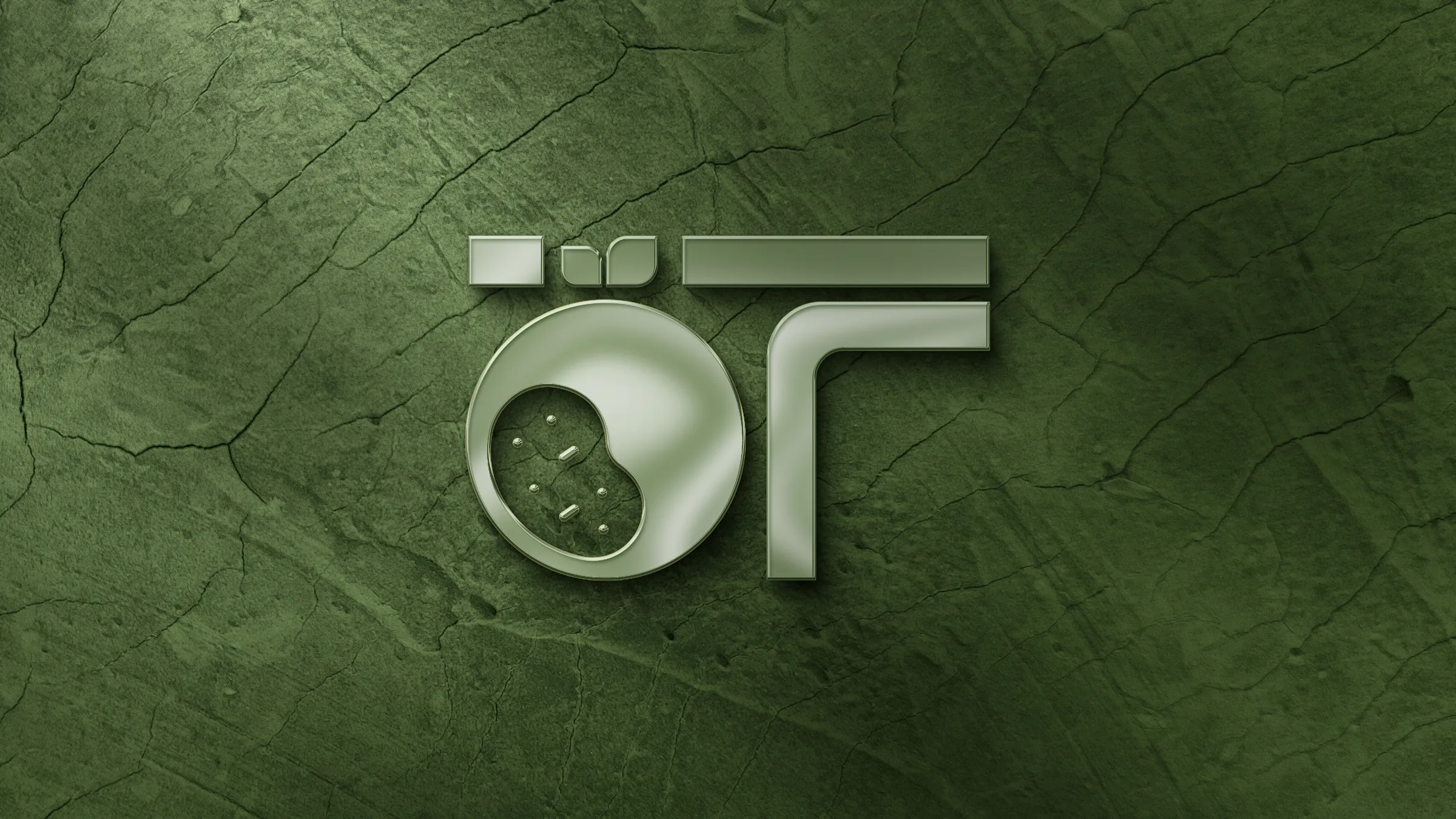 Ö–T monogramı, yeşil yaprak dokulu yüzeyde kabartma olarak.