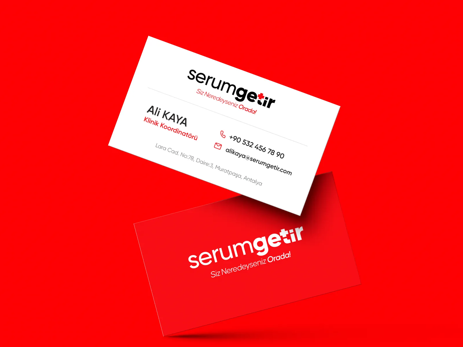 Two business cards floating over red: the white front with the logo and contact details, the red back with a white logo.