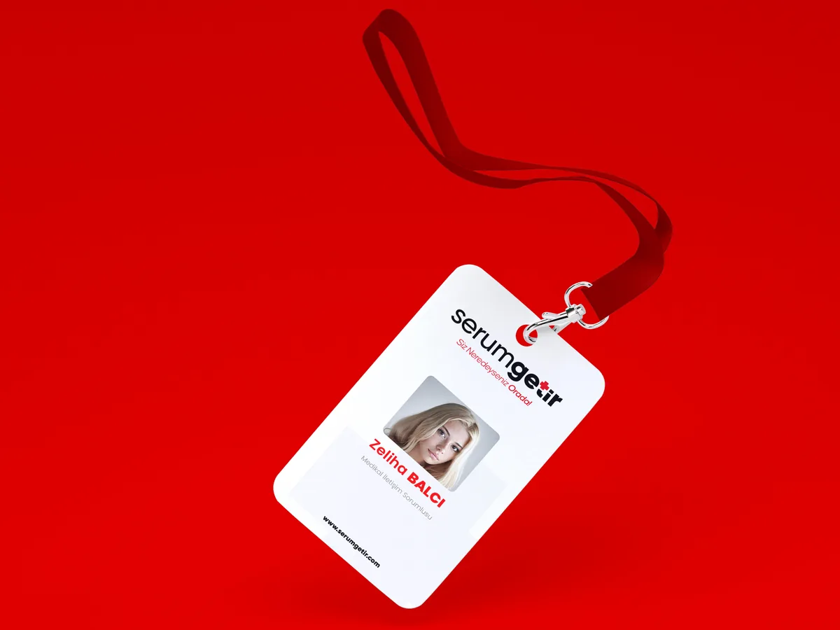 A white staff ID card on a red lanyard with the logo, a portrait photo and a name in red.