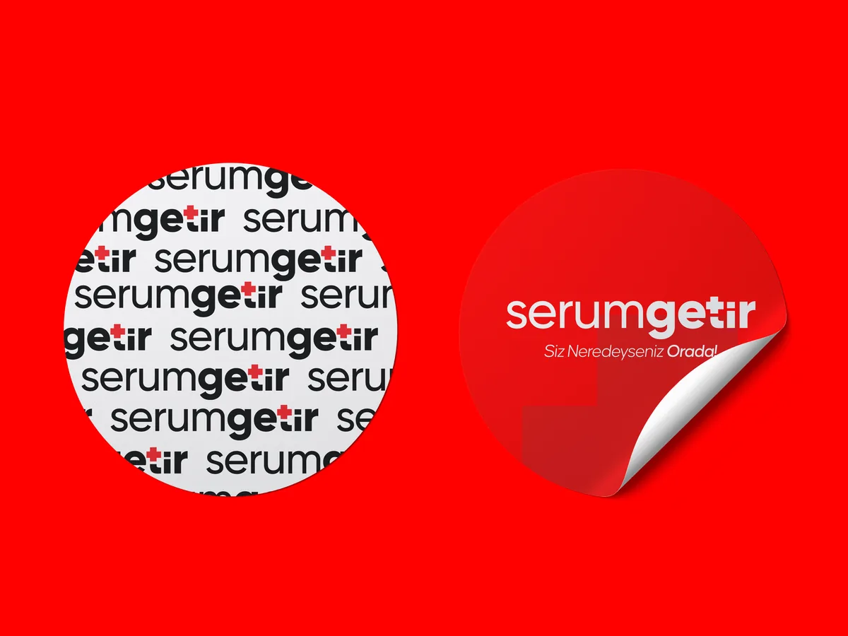 Two round stickers on red: one a pattern of repeated serumgetir wordmarks, the other a red logo sticker with a peeling corner.